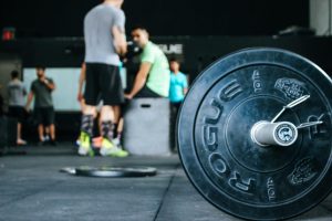 Weights in a weight room with people working out