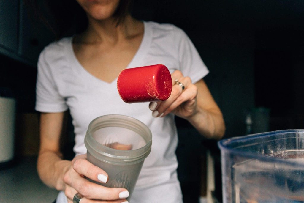 woman making protein shakeu