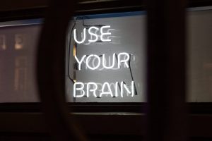 neon sign that says "use your brain"