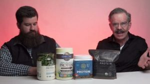 Plant Protein Powders options on table in front of Brian and Ed