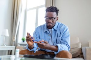 man taking blood glucose