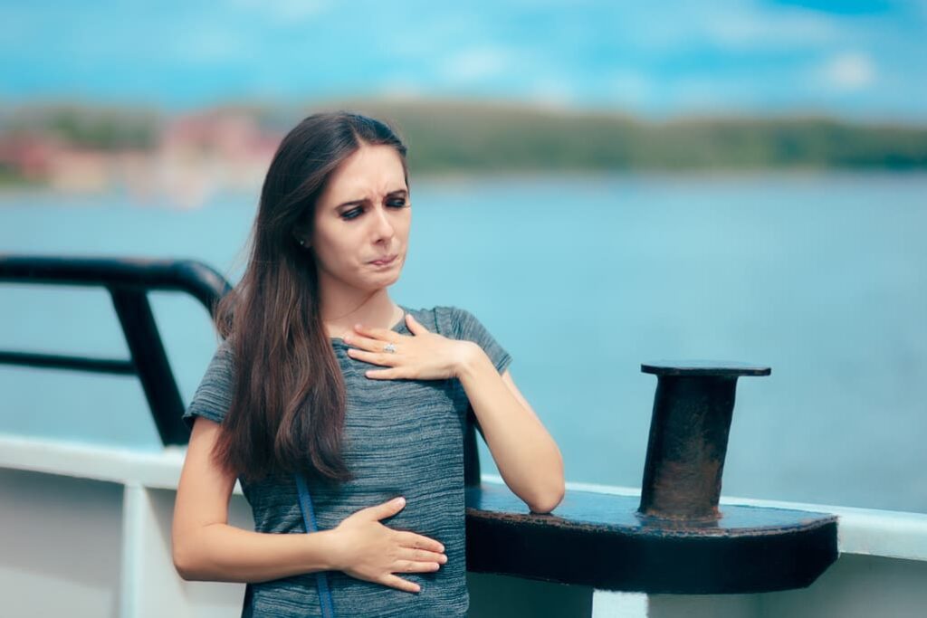 lady experiencing stomach issues on a ferry