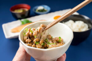 Nattokinase in bowl with chopstix