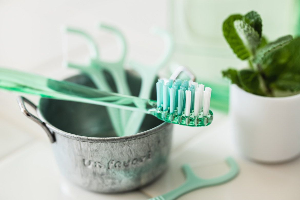 Holistic oral health concept: toothbrush, natural toothpaste, and probiotic foods